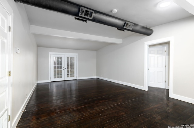 spare room featuring dark wood-type flooring, beam ceiling, and french doors