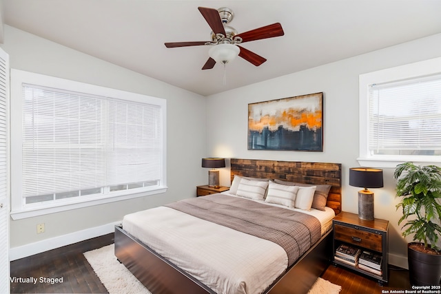 bedroom with dark hardwood / wood-style floors and ceiling fan