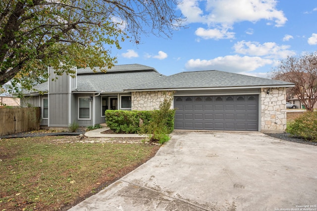 single story home featuring a garage and a front lawn