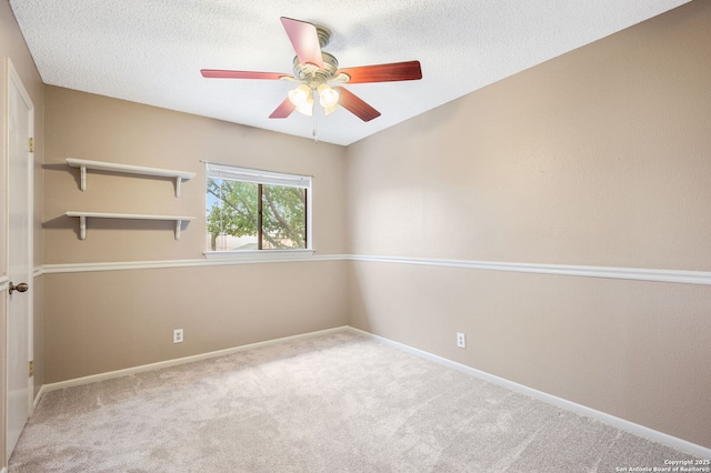 carpeted empty room with a textured ceiling and ceiling fan