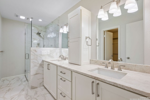 bathroom featuring vanity and a shower with shower door