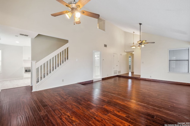 unfurnished living room featuring dark wood-type flooring, high vaulted ceiling, and ceiling fan