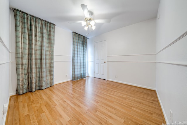 empty room with ceiling fan and light wood-type flooring