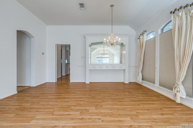 unfurnished dining area featuring a wealth of natural light, light hardwood / wood-style flooring, lofted ceiling, and a notable chandelier