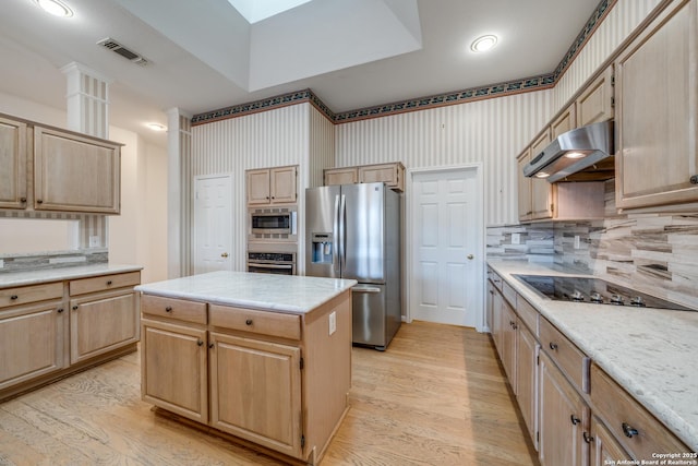 kitchen with light hardwood / wood-style floors, light brown cabinetry, appliances with stainless steel finishes, and a kitchen island