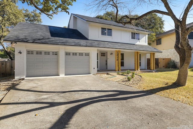 view of property with a garage and a porch