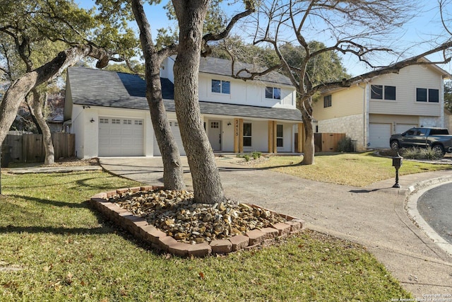 view of property featuring a garage and a front yard