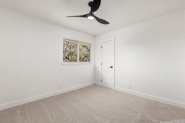 carpeted spare room featuring ceiling fan