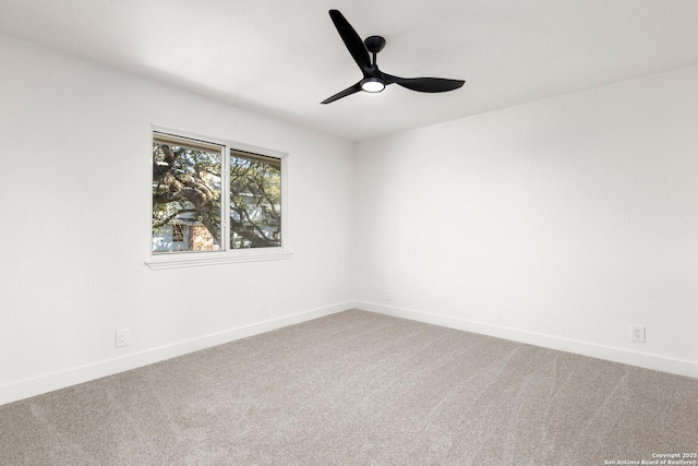 carpeted spare room with ceiling fan