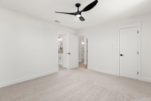 unfurnished bedroom with light colored carpet and ceiling fan