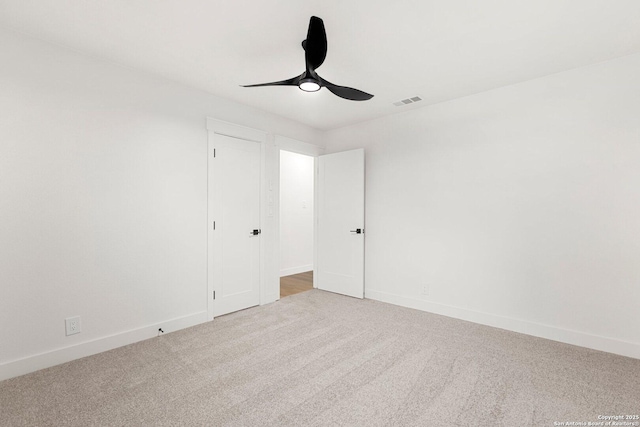 spare room with light colored carpet and ceiling fan