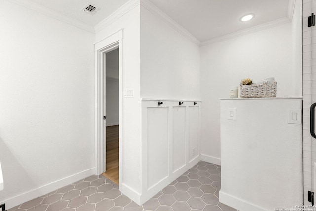 interior space featuring tile patterned flooring and ornamental molding