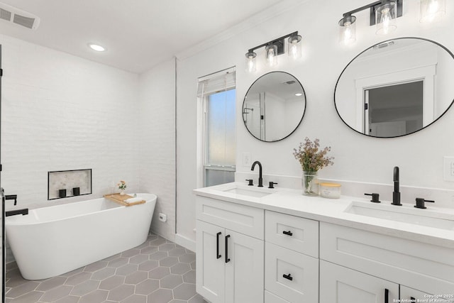 bathroom with tile patterned flooring, vanity, ornamental molding, and a bath