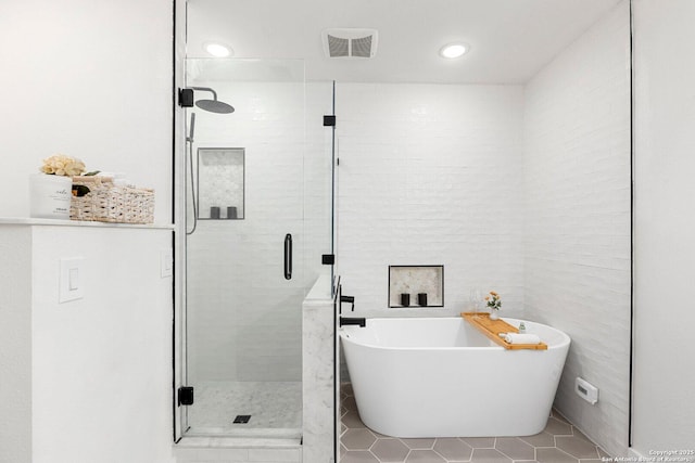 bathroom with tile patterned flooring and independent shower and bath