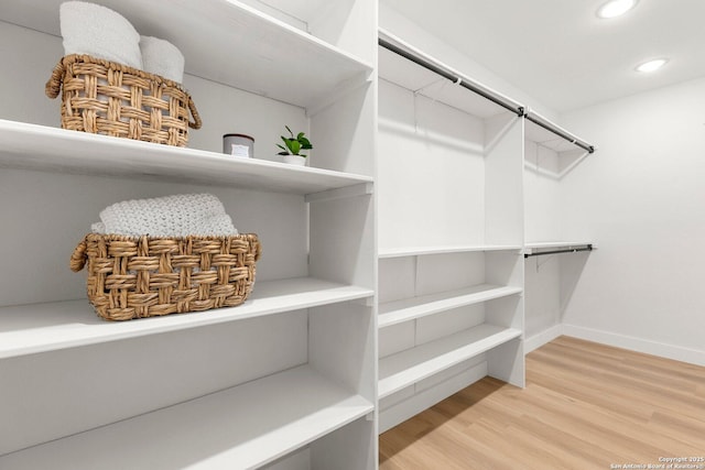 spacious closet featuring hardwood / wood-style floors