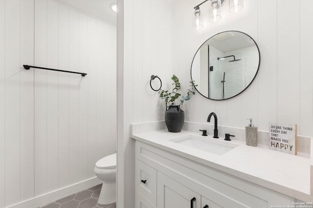 bathroom with vanity, tile patterned floors, and toilet