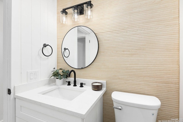 bathroom featuring vanity and toilet