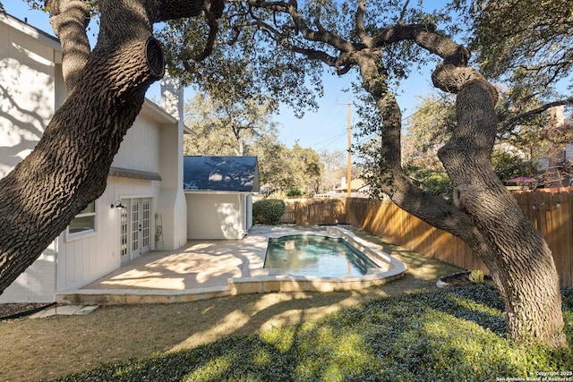 view of swimming pool with a patio area and french doors