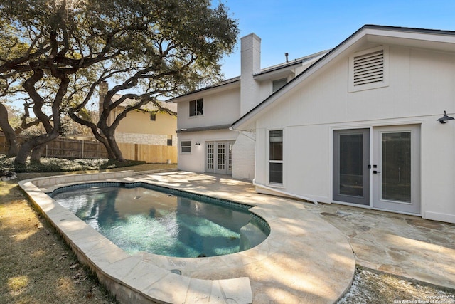 view of pool featuring a patio and french doors