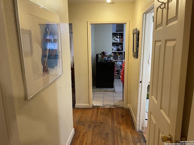 hall with dark wood-type flooring