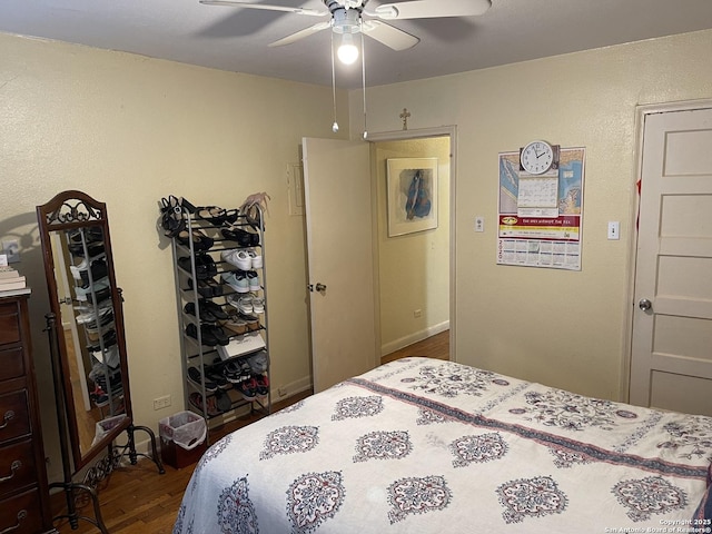 bedroom featuring ceiling fan and dark wood-type flooring