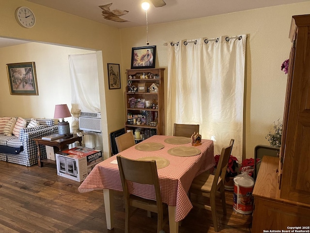 dining area featuring cooling unit and dark hardwood / wood-style floors