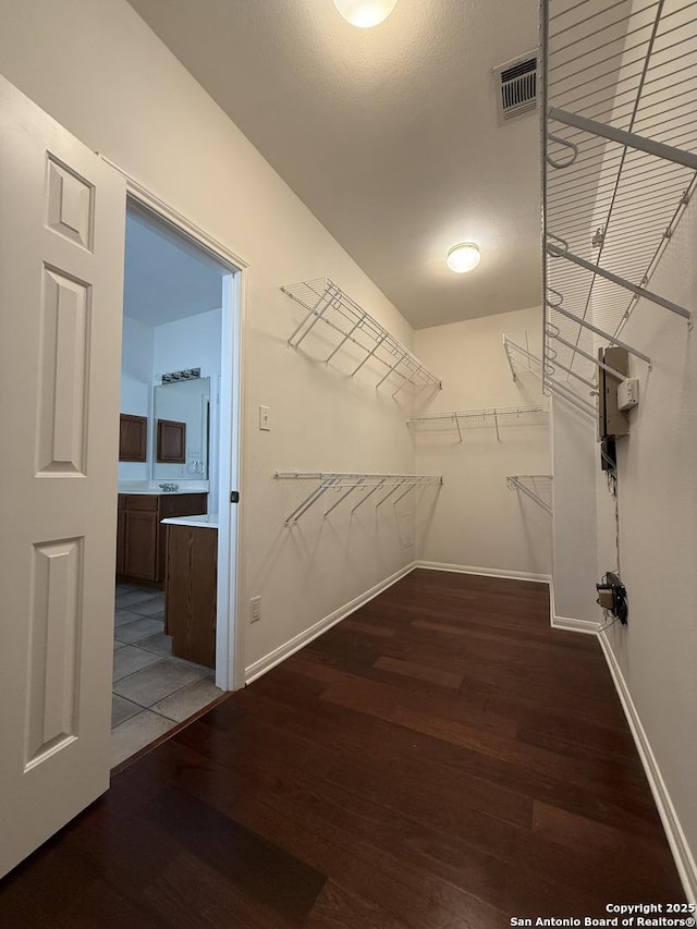 spacious closet featuring hardwood / wood-style floors