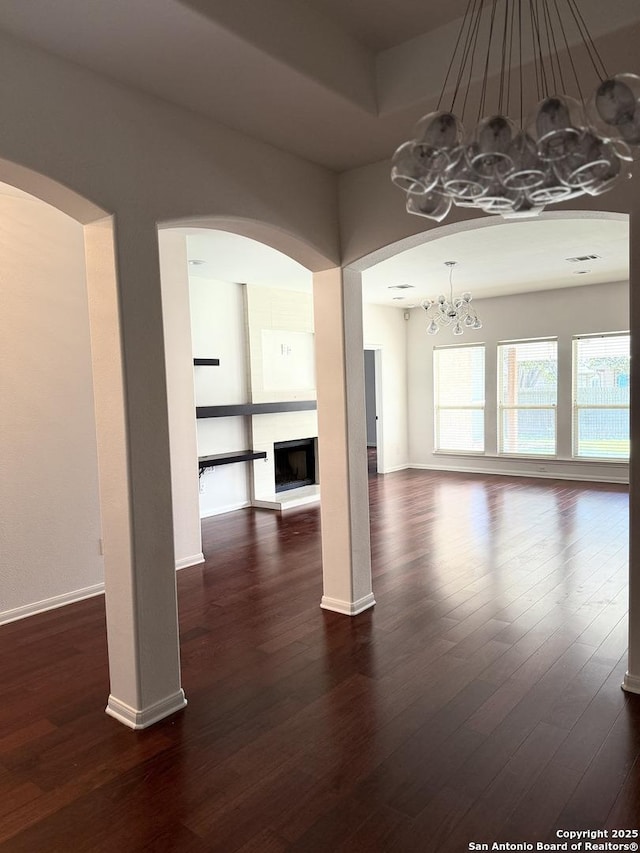 unfurnished room featuring dark hardwood / wood-style floors and a notable chandelier