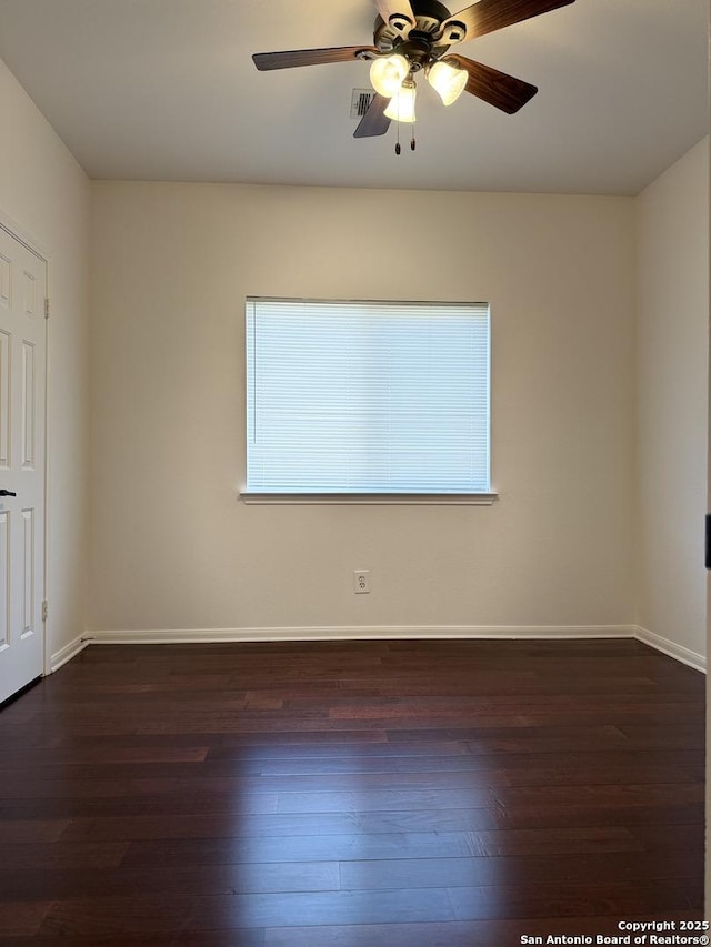 spare room with ceiling fan and dark wood-type flooring