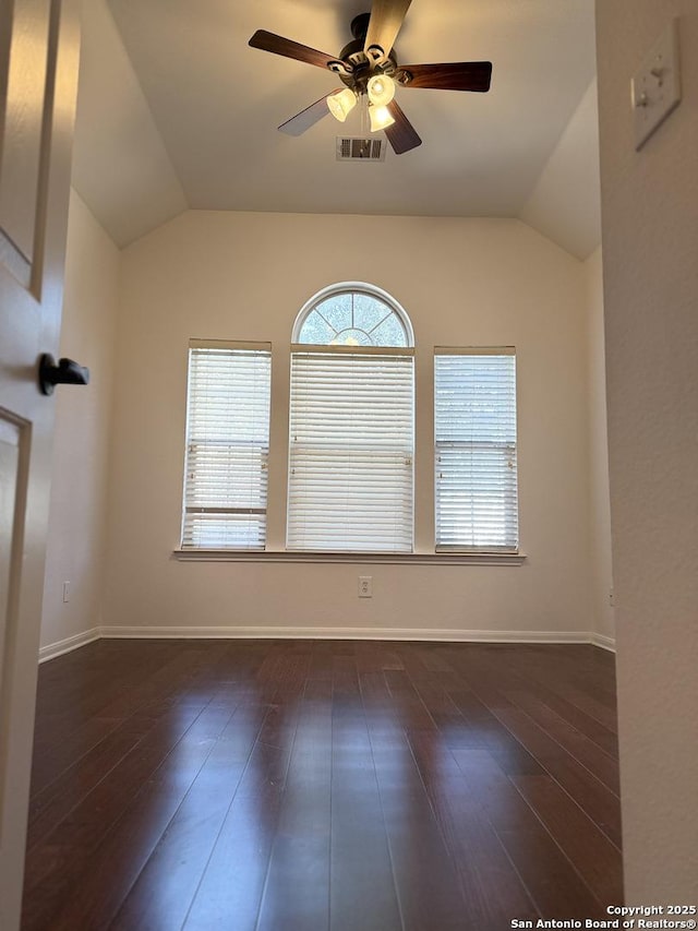 empty room featuring ceiling fan, dark hardwood / wood-style floors, and lofted ceiling