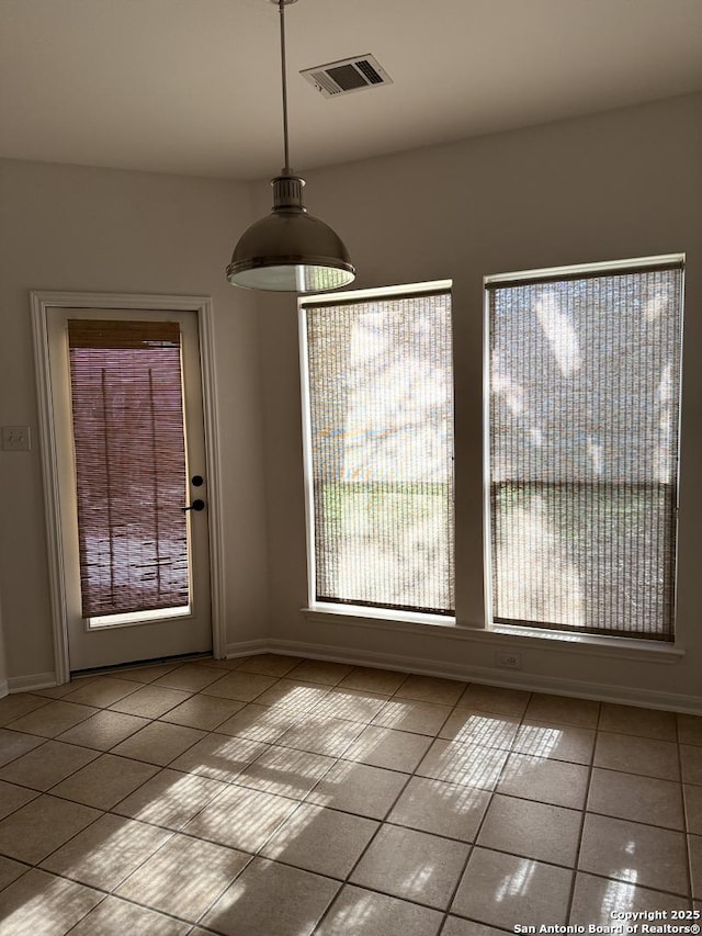 unfurnished dining area featuring light tile patterned floors