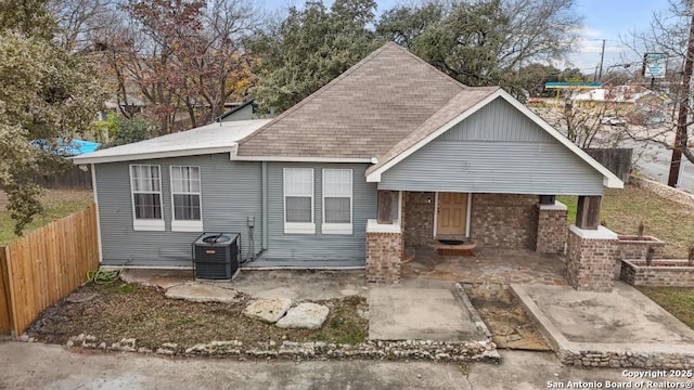 view of front of home with a patio area and central AC