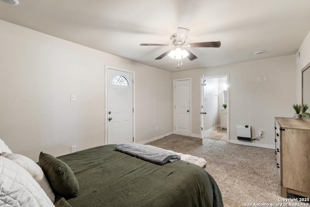 bedroom featuring ceiling fan, connected bathroom, and light colored carpet