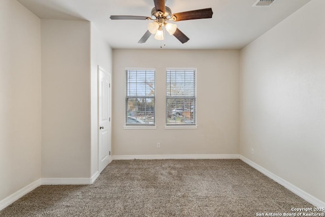 carpeted spare room featuring ceiling fan