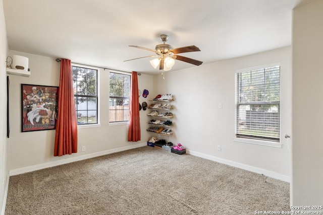 carpeted empty room with ceiling fan