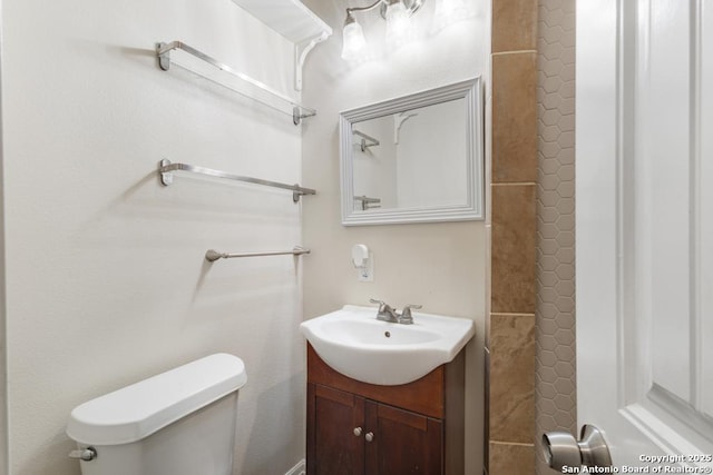 bathroom featuring a shower, toilet, and vanity