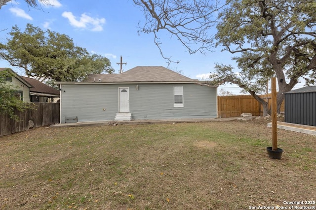 rear view of property with a lawn