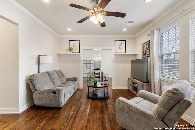 living room featuring ceiling fan with notable chandelier, dark wood-type flooring, and crown molding