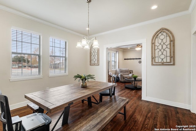 dining space with ceiling fan with notable chandelier, dark hardwood / wood-style floors, and crown molding