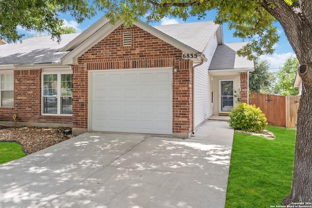 view of front of home featuring a garage and a front lawn