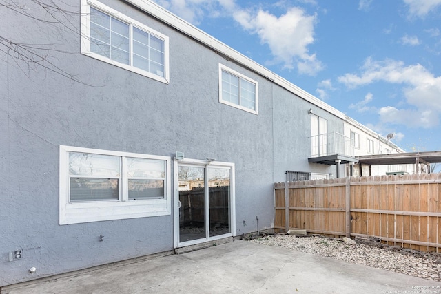 back of property with a patio