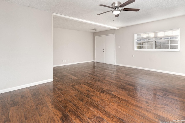 unfurnished room featuring a textured ceiling, dark hardwood / wood-style floors, and ceiling fan