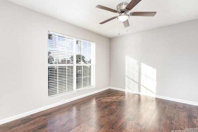 spare room with ceiling fan and dark wood-type flooring