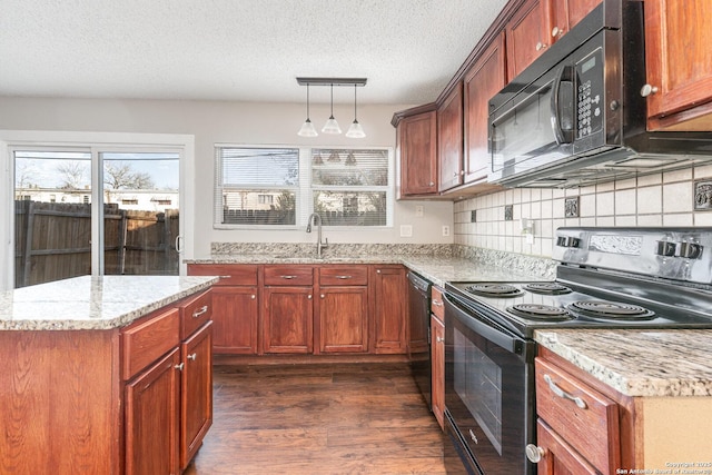 kitchen featuring hanging light fixtures, sink, tasteful backsplash, dark hardwood / wood-style floors, and black appliances