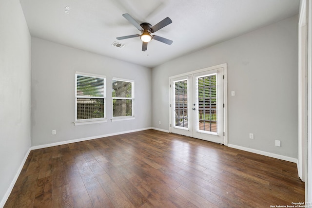 spare room with dark hardwood / wood-style floors, ceiling fan, and french doors