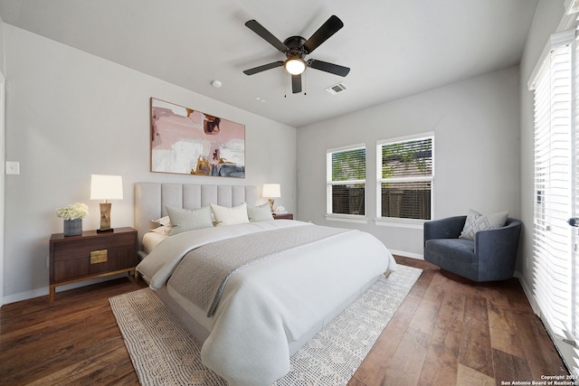 bedroom with dark hardwood / wood-style flooring and ceiling fan