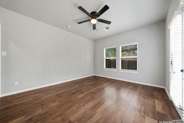 spare room featuring dark wood-type flooring and ceiling fan