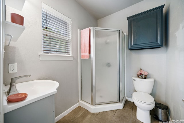 bathroom featuring tile patterned flooring, walk in shower, sink, and toilet