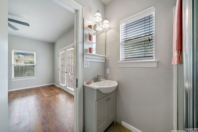 bathroom featuring vanity, wood-type flooring, and ceiling fan