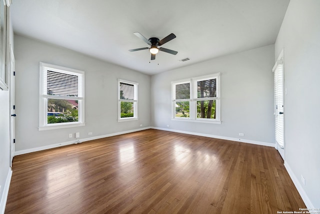 spare room featuring dark wood-type flooring and ceiling fan